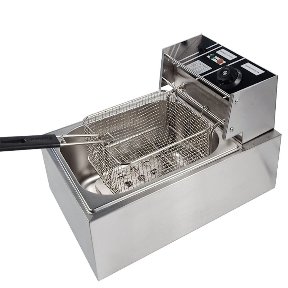 Fry basket lowered into the tank with the lid open beside it