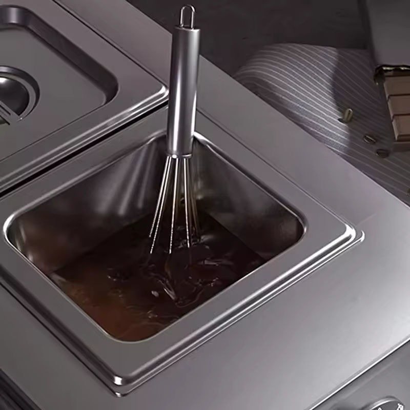 Melted chocolate in a stainless steel GN pan