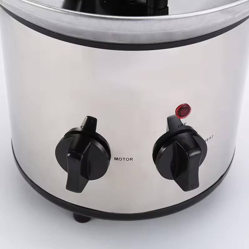 Close-up of the chocolate fountain motor and heat control knobs