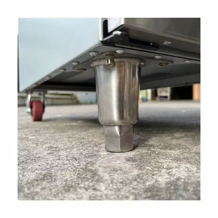 Close-up of an adjustable floor foot on the standing deep fryer cabinet