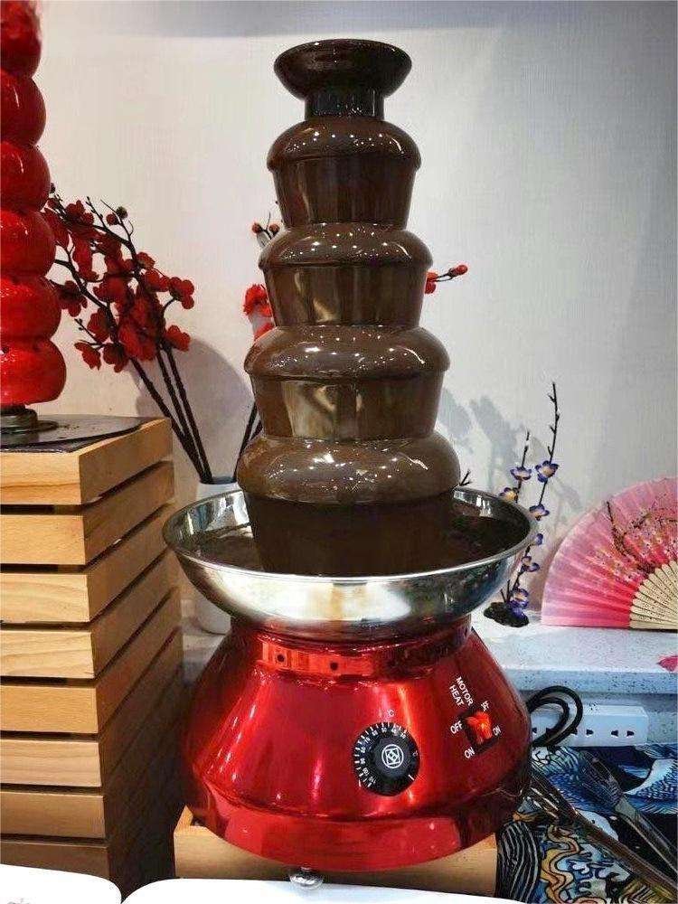 5 tier chocolate fountain flowing with chocolate, styled table setting
