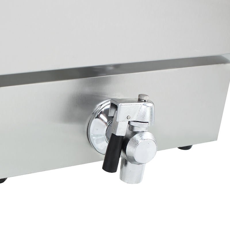Close-up of the oil drain valve on the side of the fryer